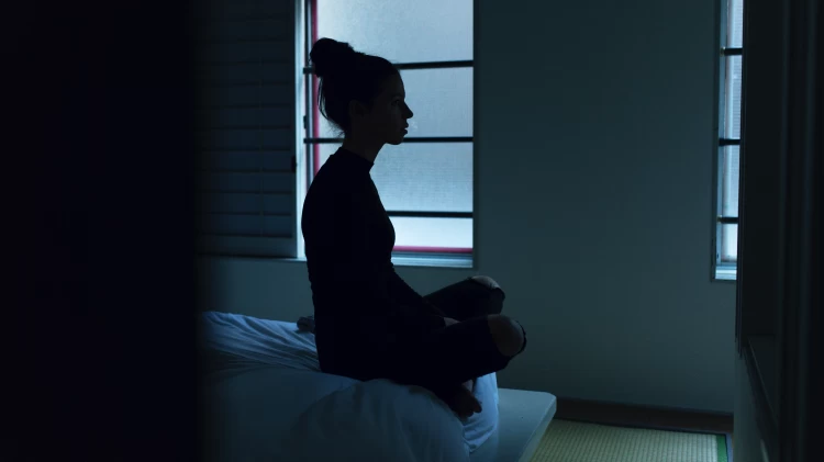 Woman Meditating In The Dark